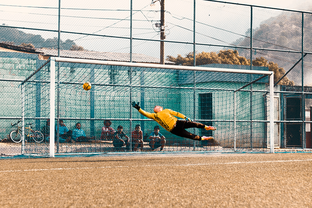 An action shot of a goalie making a save.